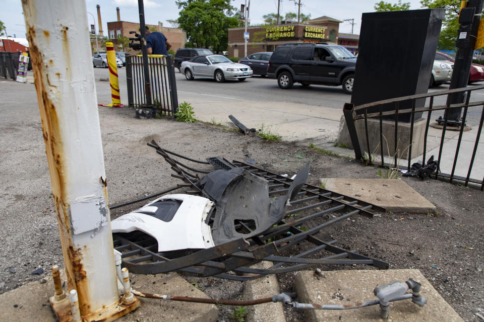 A broken fence is left at a gas station in the 800 block of North Cicero Avenue on Thursday, May 19, 2022 where Chicago police shot a 13-year-old carjacking suspect Wednesday night. The Civilian Office of Police Accountability (COPA), the agency that investigates officer-involved shootings, said the shooting happened Wednesday night on the city's far West Side after officers spotted a vehicle matching the description of one used in a carjacking in the suburb of Oak Park. (Brian Cassella/Chicago Tribune via AP)