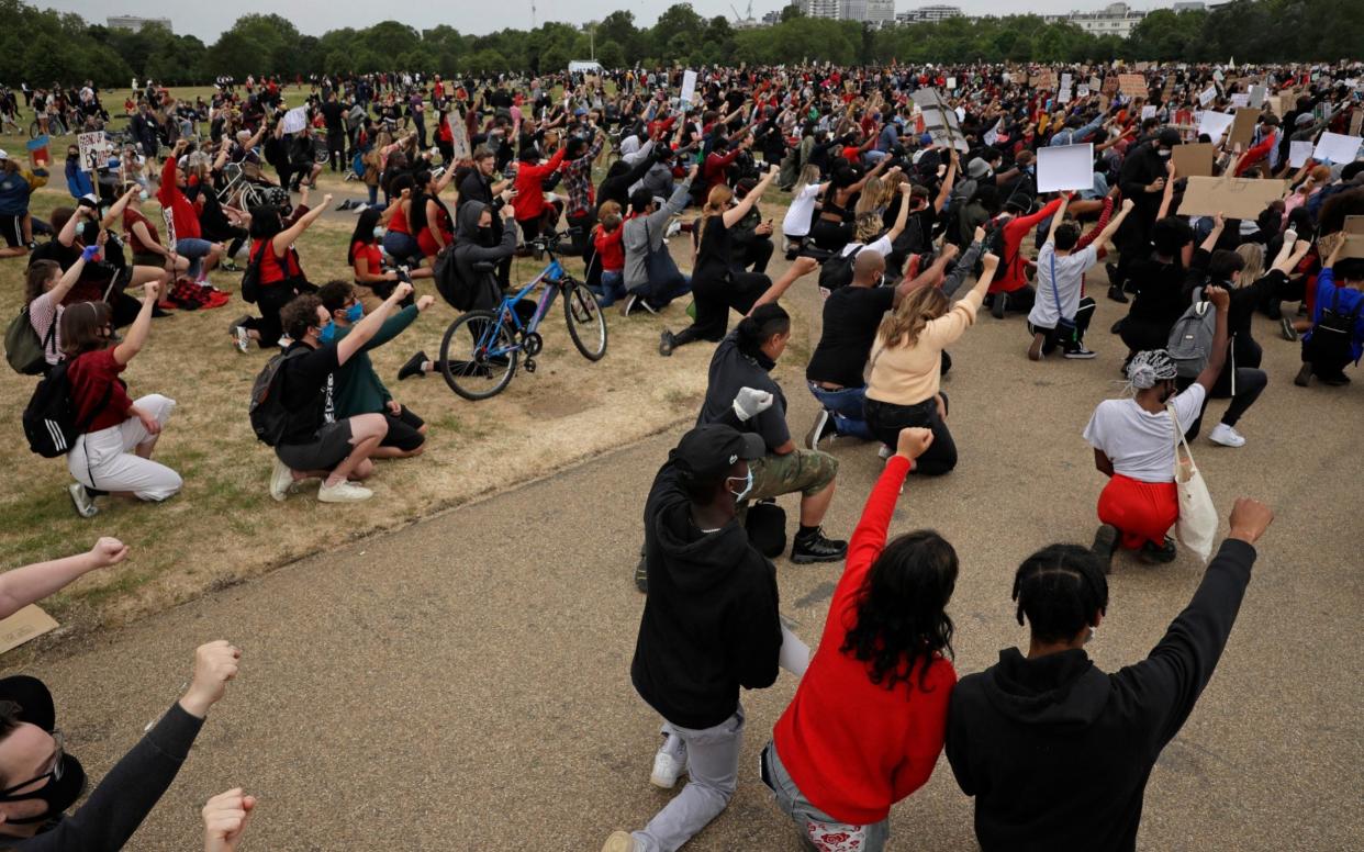 Protesters in Hyde Park take a knee as part of global demonstrations following the death of George Floyd in Minneapolis - STF/AP