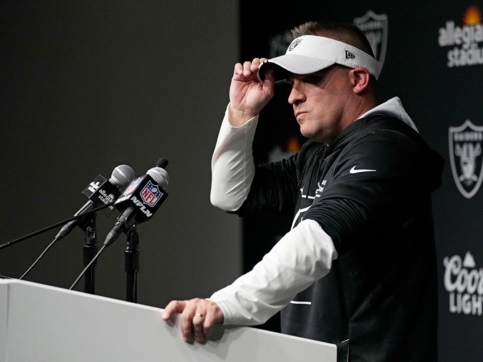 Josh McDaniels speaks with reporters during a news conference.