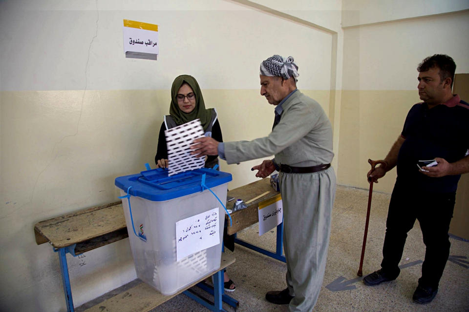 FILE - In this Sept. 30, 2018 file photo, an Iraqi Kurd casts his ballot during parliamentary elections in Irbil, Iraq. The government of Iraq's autonomous Kurdish region said Sunday, Oct. 21, 2018, that the party that led the region into its ill-fated independence referendum last year has won the most seats in regional parliamentary elections. The elections commission says the Kurdistan Democratic Party won 45 seats, 12 seats short of an outright majority in the 111-seat body. (AP Photo/Salar Salim, File)