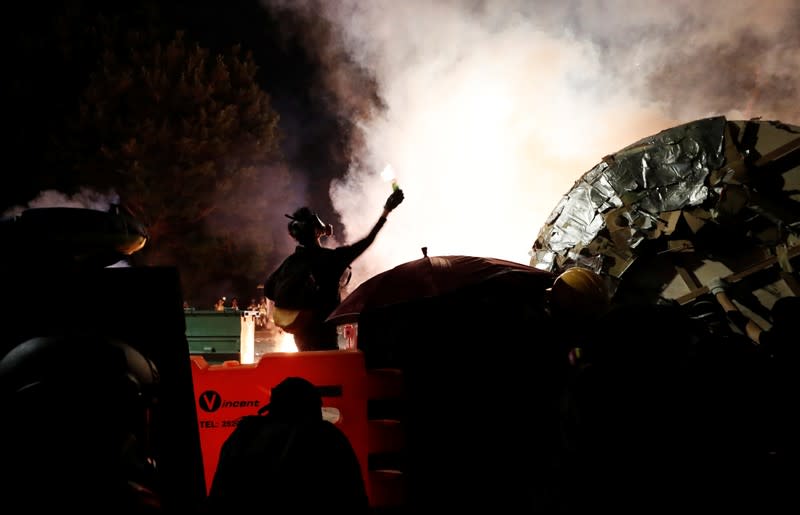 A protesters throws a molotov cocktail during a standoff with riot police at the Chinese University of Hong Kong