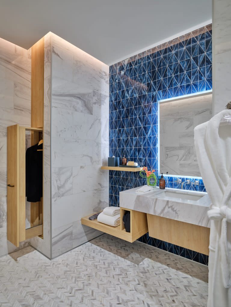 <a href="https://fortune.com/company/travelers-cos/" target="_blank">Travelers</a> can freshen up at one of eight shower suites, featuring towels, bathrobes and slippers, while valet staff members steam clothes and shine shoes.