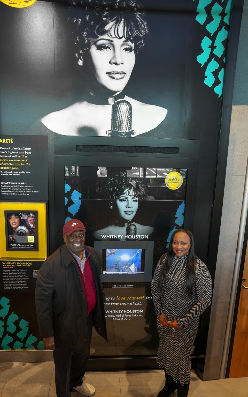 Gary Houston, Whitney Houston’s brother and former NBA basketball player, and Pat Houston, executor of The Estate of Whitney E. Houston, stand in front of the Whitney Houston installation at the Whitney Houston
Garden State Parkway Service Area.