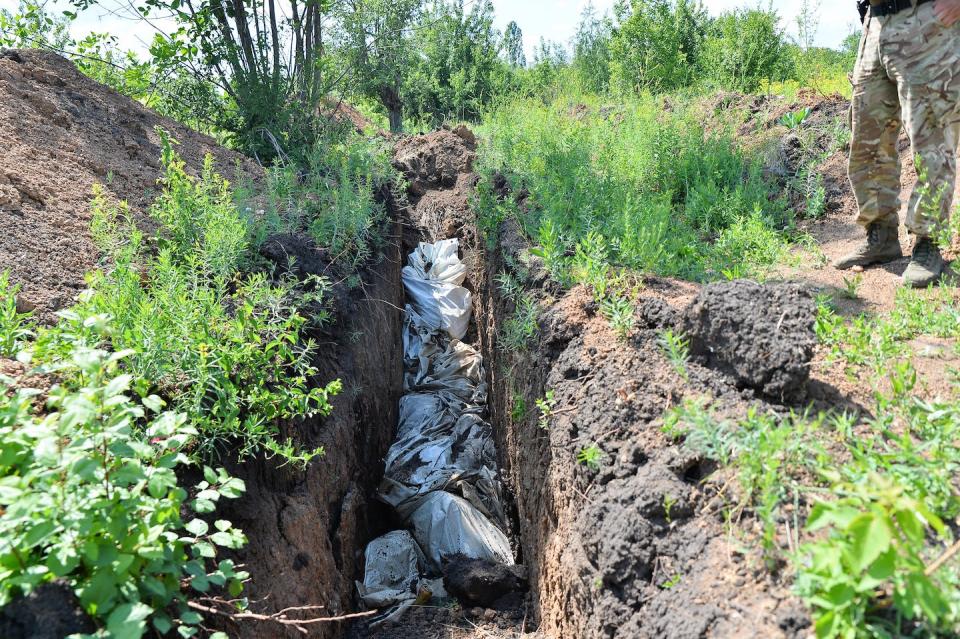 Dead bodies were found in a trench in Lysychansk, Ukraine, in June 2022. <a href="https://media.gettyimages.com/photos/dead-bodies-killed-by-the-continued-russian-barrage-were-found-in-a-picture-id1241410250?s=2048x2048" rel="nofollow noopener" target="_blank" data-ylk="slk:Madeleine Kelley/SOPA Images/LightRocket via Getty Images;elm:context_link;itc:0;sec:content-canvas" class="link ">Madeleine Kelley/SOPA Images/LightRocket via Getty Images</a>
