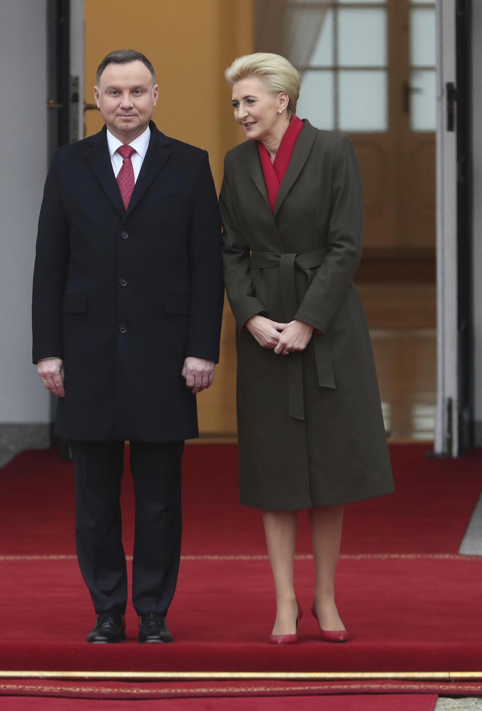 Poland's President Andrzej Duda,left, and first lady Agata Kornhauser-Duda wait to receive Danish Crown Prince Frederik and Princess Mary, before welcoming ceremony at the start of their one-day visit that marks 100 years of bilateral relations, in the Presidential Palace in Warsaw, Poland, Monday, Nov. 25, 2019.(AP Photo/Czarek Sokolowski)