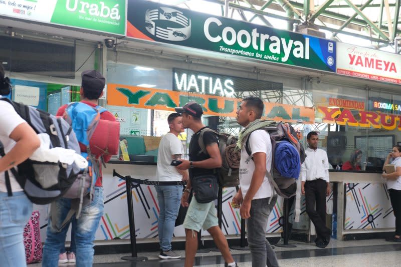 Migrants at Medellin, Colombia's north bus terminal look for available tickets to travel to the northwest cities of Turbo or Necocli where they can begin the journey through the Darien Gap, the treacherous stretch of jungle that connects Colombia and Panama. Photo by Austin Landis/UPI