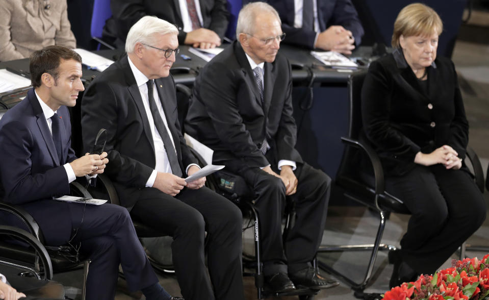 From left, France's President Emmanuel Macron, German President Frank-Walter Steinmeier, Wolfgang Schaeuble, President of the German Federal Parliament, and German Chancellor Angela Merkel attend a meeting of the German Federal Parliament, Bundestag, at the Reichstag building in Berlin, Germany, Sunday, Nov. 18, 2018 during an hour of commemoration on the 'Volkstrauertag', Germany's national day of mourning. (AP Photo/Michael Sohn)