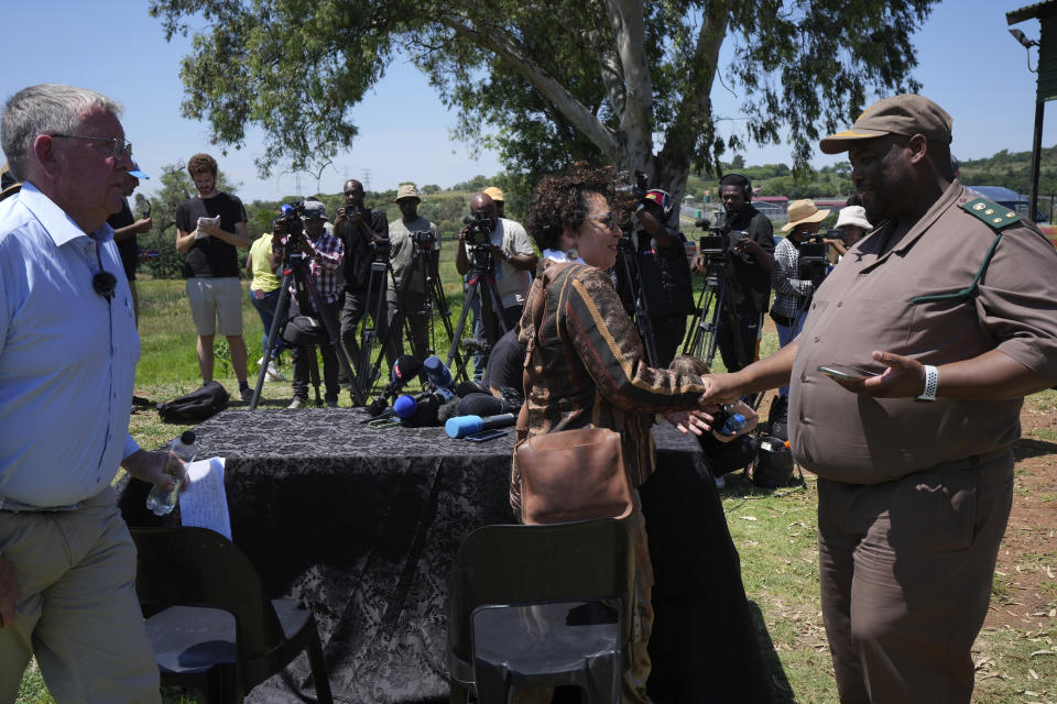 Correctional Services spokesman Singabakho Nxumalo, left, shakes hand with Advocate Annade Thiart-Hofmeyr, who read the victim impact statement, at the entrance of Atteridgeville Prison, where Oscar Pistorius is being held, following a parole hearing, in Pretoria, South Africa, Friday, Nov. 24, 2023. Pistorius has been granted parole, 10 years after shooting his girlfriend through a toilet door at his home in South Africa. Pistorius will be released from prison on Jan. 5, 2024. (AP Photo/ Tsvangirayi Mukwazhi)