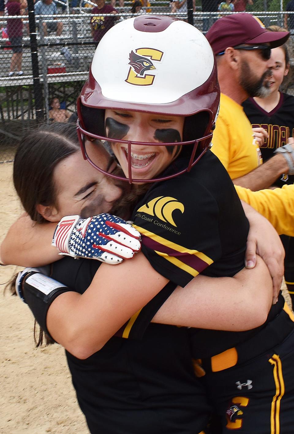 Anna Michaud hugs Skye Dupre after Dupre's grounder wins it for Case softball during last season's playoff game.