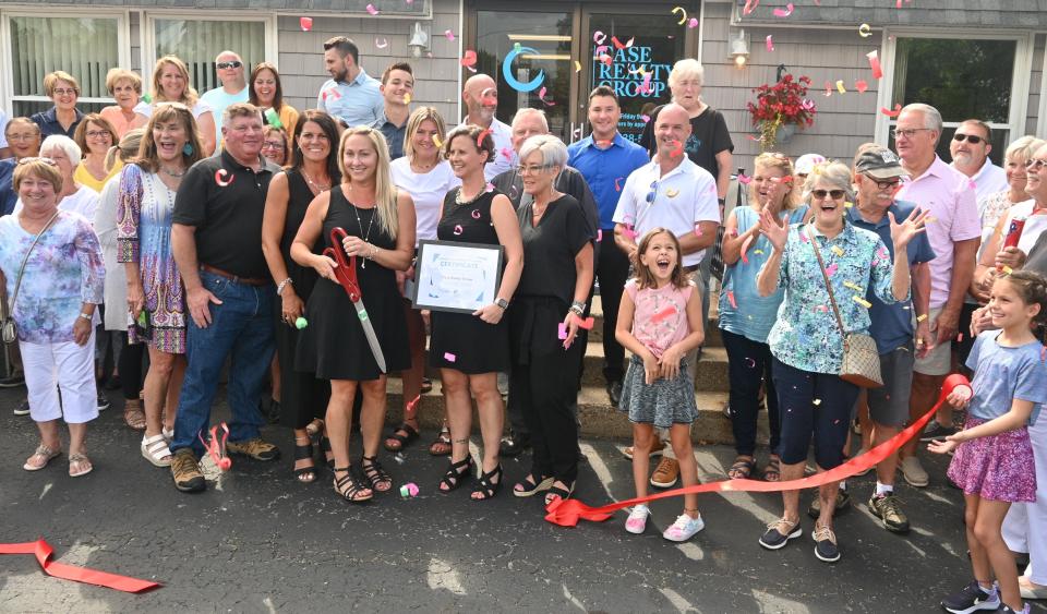 Coldwater Chamber of Commerce, with Karmen Case, cuts a red ribbon to open her Case Realty Group office Friday at 776 S. Angola Road in Kinderhook Township. Case purchased the former Sherry Haylett Realty business.