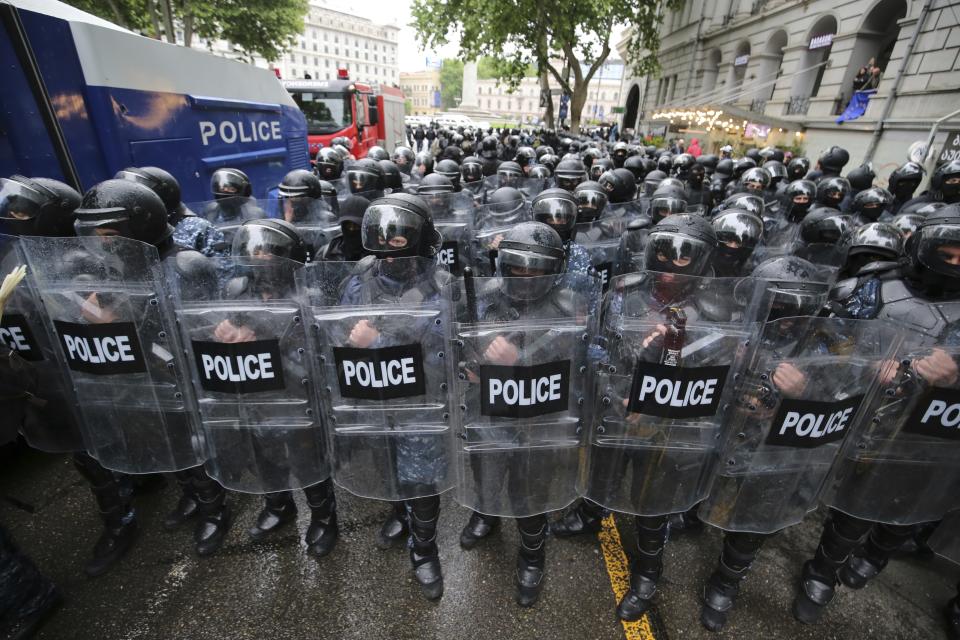 Riot police block a street to prevent demonstrators during an opposition protest against "the Russian law" near the Parliament building in the center of Tbilisi, Georgia, Tuesday, May 14, 2024. The Georgian parliament on Tuesday approved in the third and final reading a divisive bill that sparked weeks of mass protests, with critics seeing it as a threat to democratic freedoms and the country’s aspirations to join the European Union. (AP Photo/Zurab Tsertsvadze)