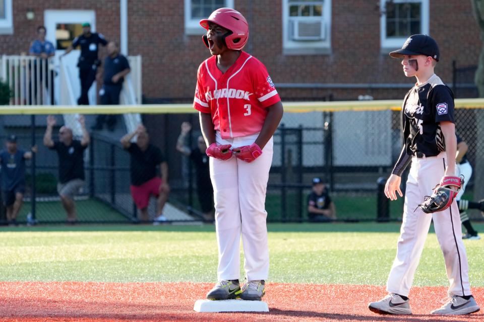 Jason Ballard, of Holbrook Little League, celebrates after hitting a double. Sunday, July 30, 2023