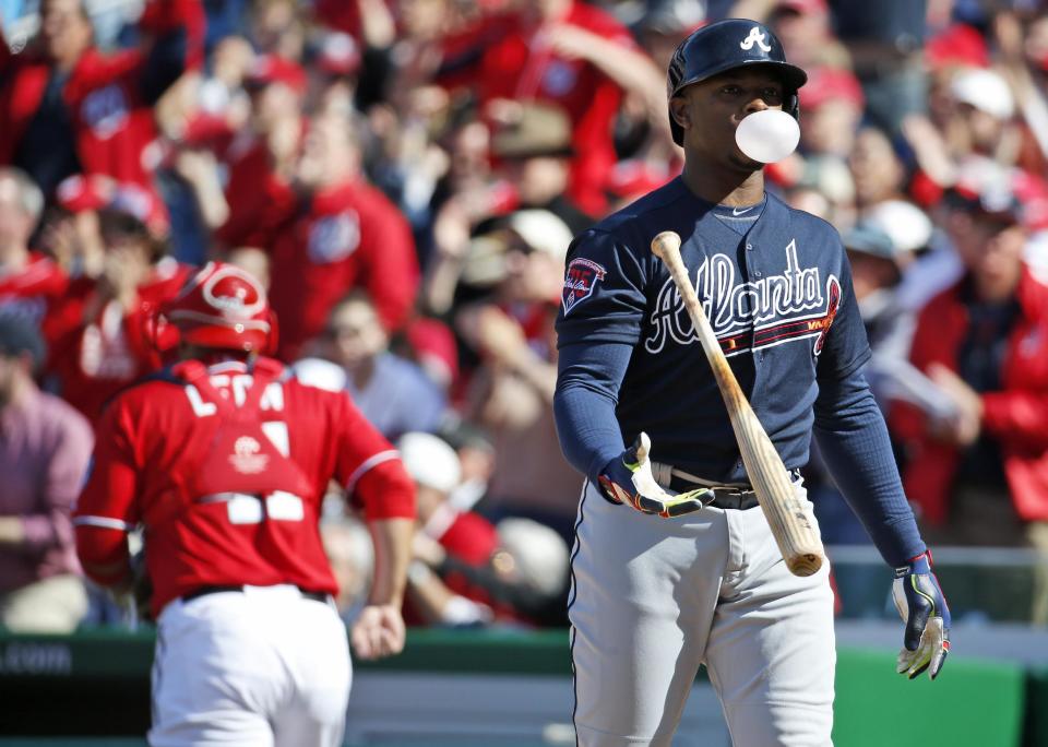 Atlanta Braves' Justin Upton blows a bubble as he flips his bat after striking out during the eighth inning of a baseball game against the Washington Nationals at Nationals Park, Sunday, April 6, 2014, in Washington. The Nationals won 2-1. (AP Photo/Alex Brandon)