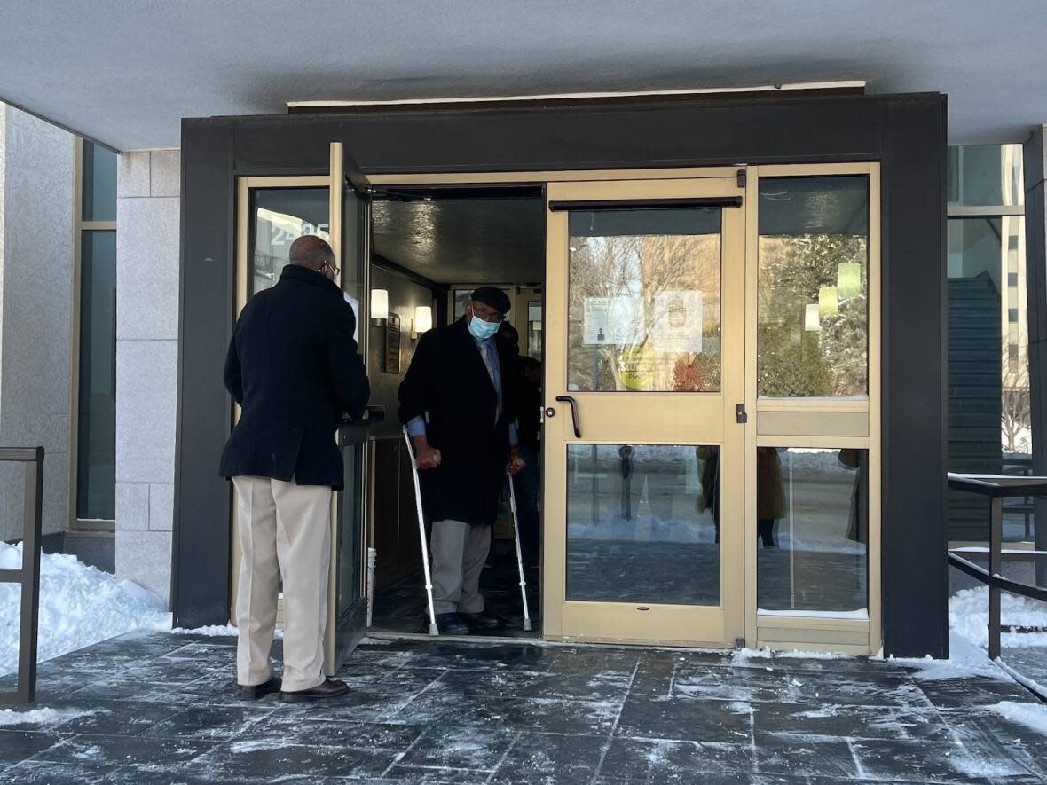 Sylvester Ukabam, right, is shown at Court of Queen's Bench in Regina on Monday, Jan.10, 2022. Ukabam, a 76-year-old former doctor, is accused of sexually assaulting patients during medical exams between 2010 and 2017. He has pleaded not guilty to all counts.  (Mickey Djuric/The Canadian Press - image credit)