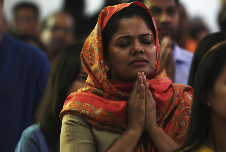 In this Sunday, Jan. 20, 2019 photo, a woman prays during Mass at St. Mary's Catholic Church in Dubai, United Arab Emirates. Pope Francis’ visit to the United Arab Emirates from Feb. 3 through Feb. 5, marks the first ever papal visit to the Arabian Peninsula, the birthplace of Islam. The Catholic Church believes there are some 1 million Catholics in the UAE today. The backbone of that population is Filipino and Indian. (AP Photo/Jon Gambrell)