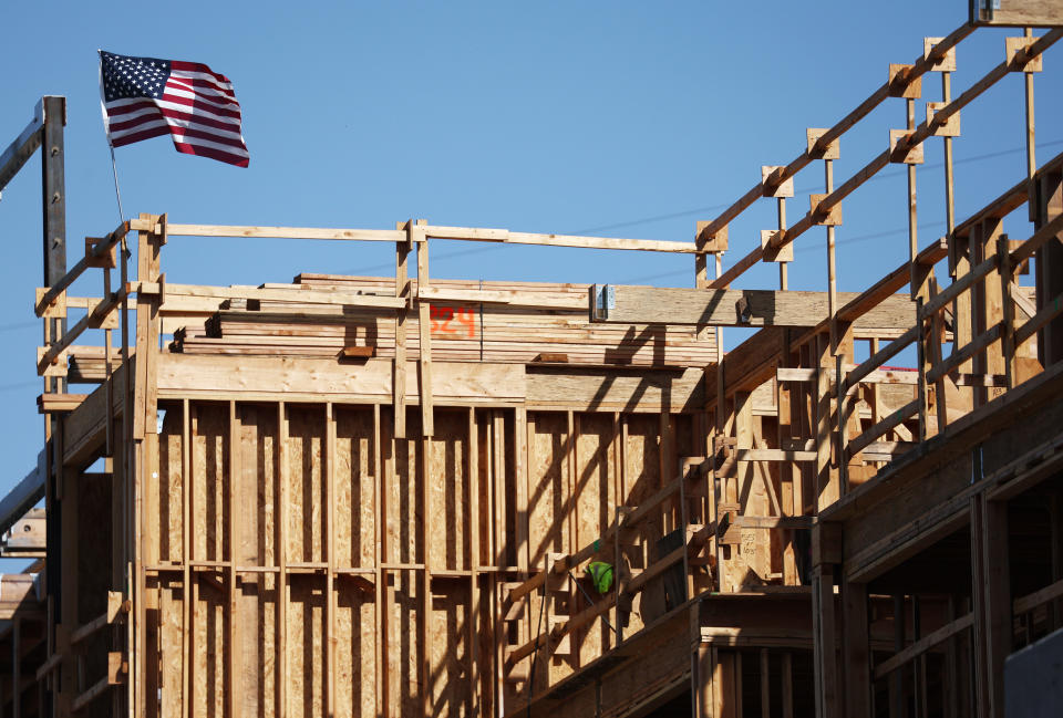 LOS ANGELES, CALIFORNIA - JUNE 02: An American flag flies above the construction site of a multifamily housing development on June 02, 2023 in Los Angeles, California. Today’s U.S. labor report shows that employers added 339,000 jobs in May with sectors including construction, healthcare, business services and transportation adding jobs with wages showing 4.3 percent growth over the same period last year.  (Photo by Mario Tama/Getty Images)