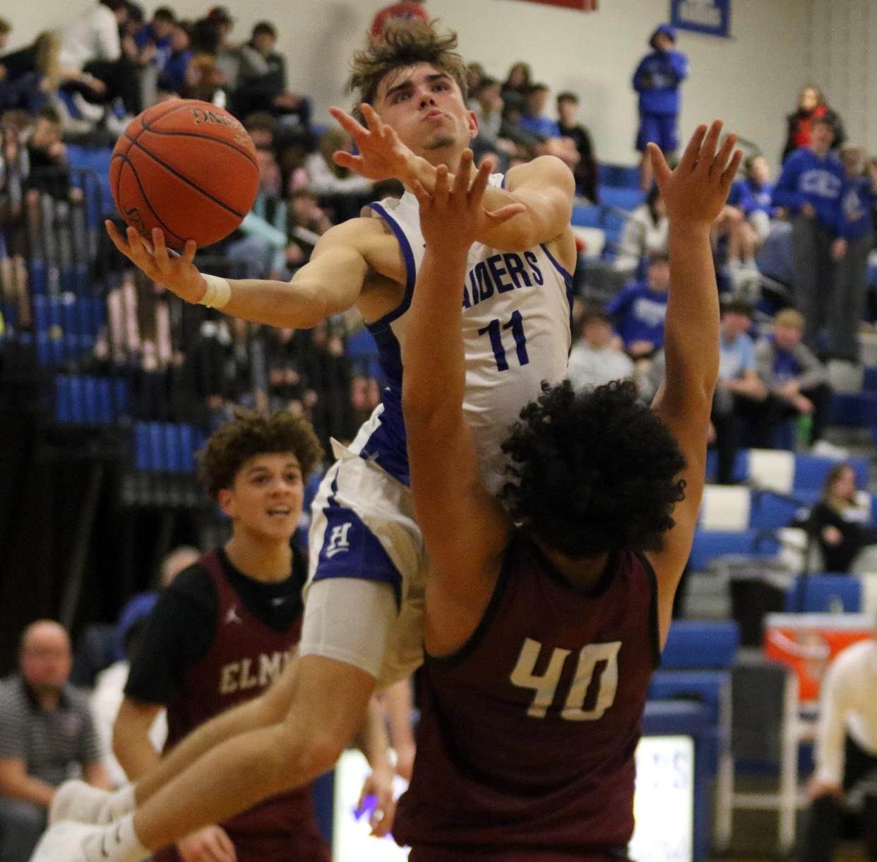 Horseheads' Alex Daugherty goes up for a shot as Elmira's Chris Woodard defends during the Blue Raiders' 72-53 win in boys basketball Jan. 19, 2023 at Horseheads Middle School.