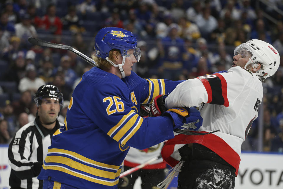 Buffalo Sabres defenseman Rasmus Dahlin (26) and Ottawa Senators center Josh Norris (9) shove each other during the second period of an NHL hockey game Thursday, Oct. 13, 2022, in Buffalo, N.Y. (AP Photo/Joshua Bessex)