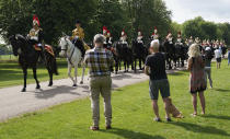 Members of the Household Cavalry make their way along the Long Walk towards Windsor Castle, Windsor, England, Saturday June 12, 2021, ahead of a ceremony to mark the official birthday of Queen Elizabeth II. (Andrew Matthews/PA via AP)