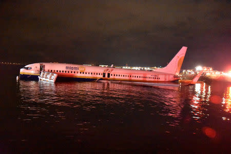 A Miami Air, Boeing 737 aircraft from Naval Station Guantanamo Bay, Cuba, sits in shallow water of the St Johns River after it slid off the runway at Naval Air Station Jacksonville, Florida, U.S., May 3, 2019. U.S. Navy/Senior Chief Mass Communication Specialist Monica R. Hopper/Handout via REUTERS