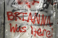 Graffiti is show on the damaged base of a Confederate memorial that was removed overnight in Birmingham, Ala., on Tuesday, June 2, 2020. The city took down the more than 50-foot-tall obelisk following protests over the police death of George Floyd and a night of vandalism in the city. Demonstrators used rocks, hammers and paint to deface the monument. (AP Photo/Jay Reeves)