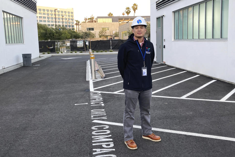 Sunny Wang, water resources manager for Santa Monica, stands in a parking lot near the entrance to the city's underground storm and wastewater treatment facility on Tuesday, Jan. 17, 2023, in Santa Monica, Calif. In Santa Monica, the new water project captured nearly 2 million gallons (7,600 cubic meters) of runoff that once treated gets used for plumbing, irrigation or pumped back into the city’s aquifer. Wang said the project will eventually save an average of about 40 million gallons (151,000 cubic meters) per year. (AP Photo/Brian Melley)
