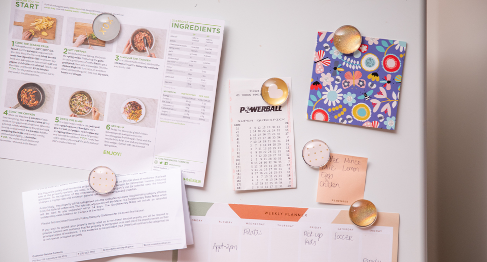 A Powerball Quickpick ticket on a fridge. 