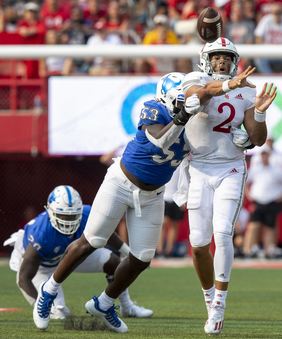 Nebraska quarterback Adrian Martinez (2) gets hit by Buffalo's C. J. Bazile (53) as he throws in the third quarter of an NCAA college football game Saturday, Sept. 11, 2021, in Lincoln, Neb. (Francis Gardler/Lincoln Journal Star via AP)