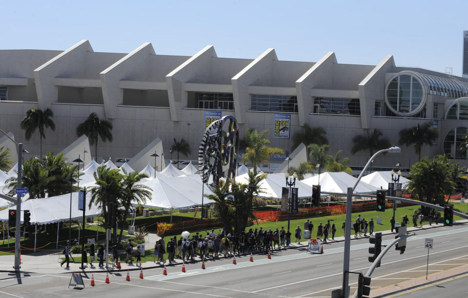 Fans walk past the Hall H line up area outside the San Diego Convention Center as they head to the Preview Night event on Day 1 of the 2013 Comic-Con International Convention on Wednesday, July 17, 2013, in San Diego. (Photo by Denis Poroy/Invision/AP)