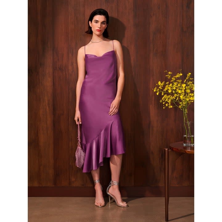 a model wearing the dress in purple