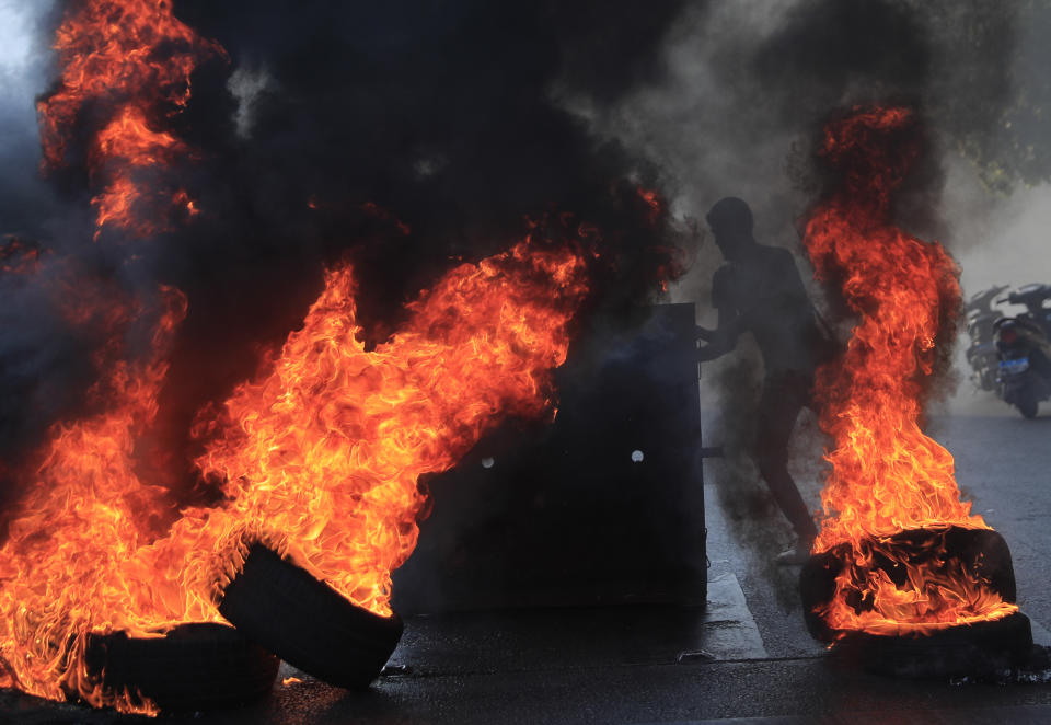 Saad Hariri's supporters block streets in Beirut, Lebanon, Thursday, July 15, 2021. Prime Minister-designate Saad Hariri says he is stepping down, nine months after he was named to the post by the parliament. He is citing "key differences" with the country's president, Michel Aoun. Thursday's announcement is likely to plunge the country further into more chaos and uncertainty. (AP Photo/Hussein Malla)