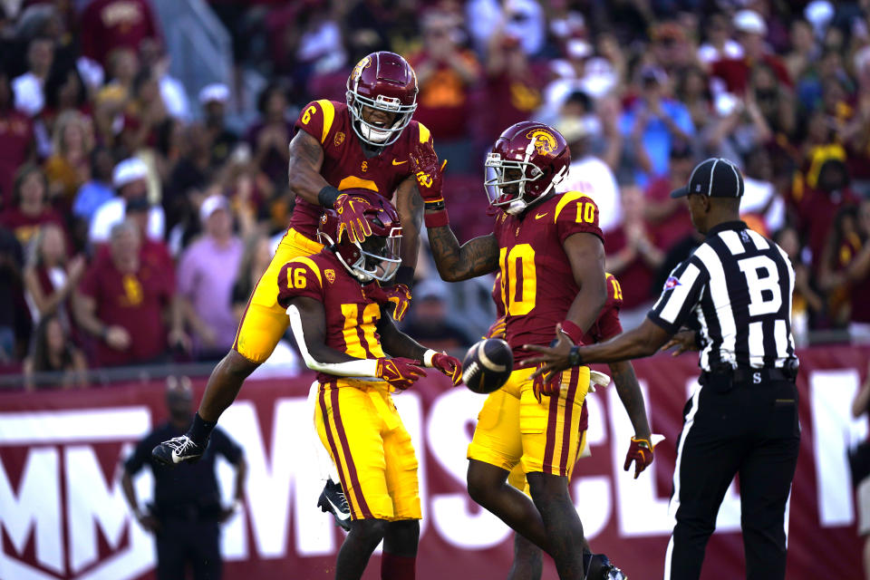 Southern California wide receiver Tahj Washington celebrates with teammates after scoring a touchdown on a pass from quarterback Caleb Williams during the first half of an NCAA college game against San Jose State, Saturday, Aug. 26, 2023, in Los Angeles. (AP Photo/Ryan Sun)