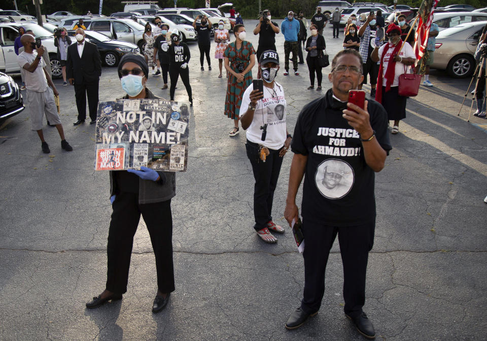 People listen to speakers in Atlanta before driving down to Brunswick. Ga. for a rally to protest the shooting of Ahmaud Arbery, Saturday, May 16, 2020. (Steve Schaefer/Atlanta Journal-Constitution via AP)