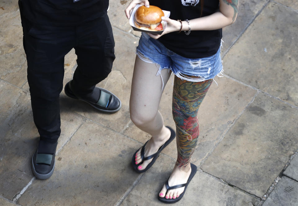 <p>A visitor displays her tattoos at The International Tattoo Convention in London, Friday, Sept. 22, 2017. (Photo: Kirsty Wigglesworth/AP) </p>