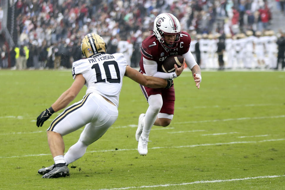 South Carolina quarterback Spencer Rattler (7) runs past Vanderbilt linebacker Langston Patterson (10) for a one-yard touchdown during the first half of an NCAA college football game on Saturday, Nov. 11, 2023, in Columbia, S.C. (AP Photo/Artie Walker Jr.)