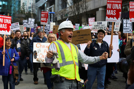 A construction worker chants along with protestors as they march through downtown Seattle in support of Daniel Ramirez Medina, who was detained by U.S. immigration authorities, in Seattle, Washington, U.S. February 17, 2017. REUTERS/David Ryder