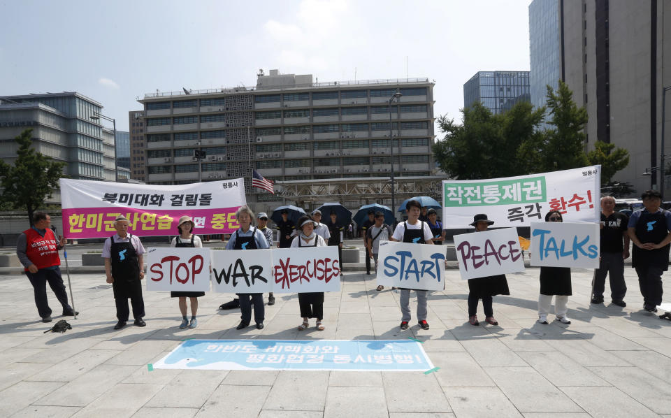 Protesters stand with banners to oppose planned joint military exercises between South Korea and the United States near the U.S. embassy in Seoul, South Korea, Monday, Aug. 5, 2019. The both countries are preparing to hold their annual joint military exercises despite warnings from North Korea that the drills could derail the fragile nuclear diplomacy, Seoul's military said Friday. The banners written in the Korean letters read: "Stop an annual joint military exercises between South Korea and the United States." (AP Photo/Ahn Young-joon)