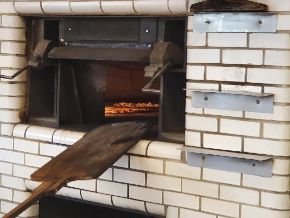 Pizzas cook inside the coal-burning oven, the same way pizzas have been made at Pepe’s for 94 years.