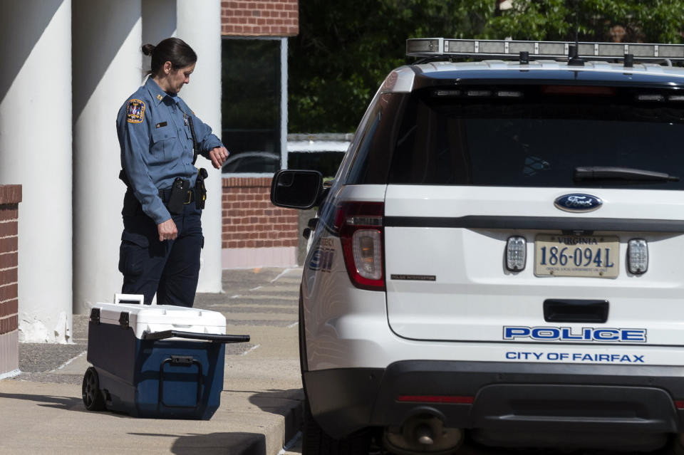 An officer stands outside the Fairfax, Va., office building where police say a man wielding a baseball bat attacked two staffers for U.S. Rep. Gerry Connolly, D-Va., on Monday, May 15, 2023. Fairfax City Police in northern Virginia said in a tweet that a suspect is in custody and the victims are being treated for injuries that are not life-threatening. (AP Photo/Cliff Owen)