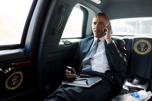 US President Barack Obama talking on the phone with Aurora Mayor Steve Hogan during the motorcade ride to Palm Beach International Airport in Palm Beach, Florida, on July 20, in a picture provided by the White House. Obama called Mayor Hogan to offer his condolences and support to the Aurora community following the shocking shooting at a movie theater that left 12 people dead and nearly 60 hurt