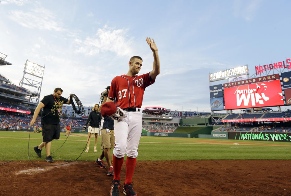 FILE - Washington Nationals starting pitcher Stephen Strasburg acknowledges the fans as he comes off the field after a baseball game against the Philadelphia Phillies at Nationals Park, Aug. 11, 2013, in Washington. Strasburg, the 2019 World Series MVP whose career was derailed by injuries, officially was listed by Major League Baseball on Saturday, April 6, 2024, as being retired. (AP Photo/Alex Brandon, File)