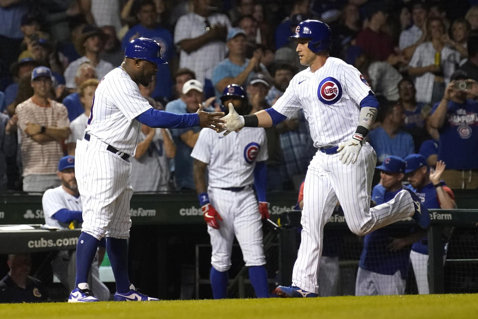 Chicago Cubs' Yan Gomes, right, celebrates his home run off San Diego Padres starting pitcher Yu Darvish with third base coach Willie Harris during the second inning of a baseball game Monday, June 13, 2022, in Chicago. (AP Photo/Charles Rex Arbogast)