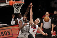 Brooklyn Nets guard Kyrie Irving (11) loses the ball driving to the basket past Miami Heat forward Kelly Olynyk (9) during the first half of an NBA basketball game Monday, Jan. 25, 2021, in New York. (AP Photo/Adam Hunger)