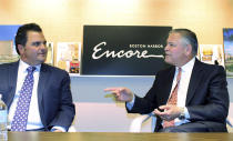 In this June 7, 2019 photo, Encore Boston Harbor casino president Robert DeSalvo, right, speaks to Everett Mayor Carlo DeMaria in the company's administrative office in Medford, Mass. The casino is scheduled to open in nearby Everett on Sunday, June 23. (AP Photo/Philip Marcelo)