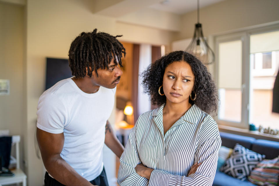 A man and woman arguing in a living room