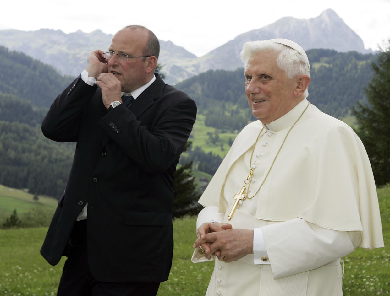 FILE - Pope Benedict XVI is followed by his personal bodyguard Domenico Giani as he visits the home of late missionary Josef Freinademetz, who was made saint after doing his mission in China, and pray in the church devoted to him, in Oies, Alta Badia, Italy, on Aug. 5, 2008. Pope Emeritus Benedict XVI, the German theologian who will be remembered as the first pope in 600 years to resign, has died, the Vatican announced Saturday. He was 95. (AP Photo/Alberto Pellaschiar, File)