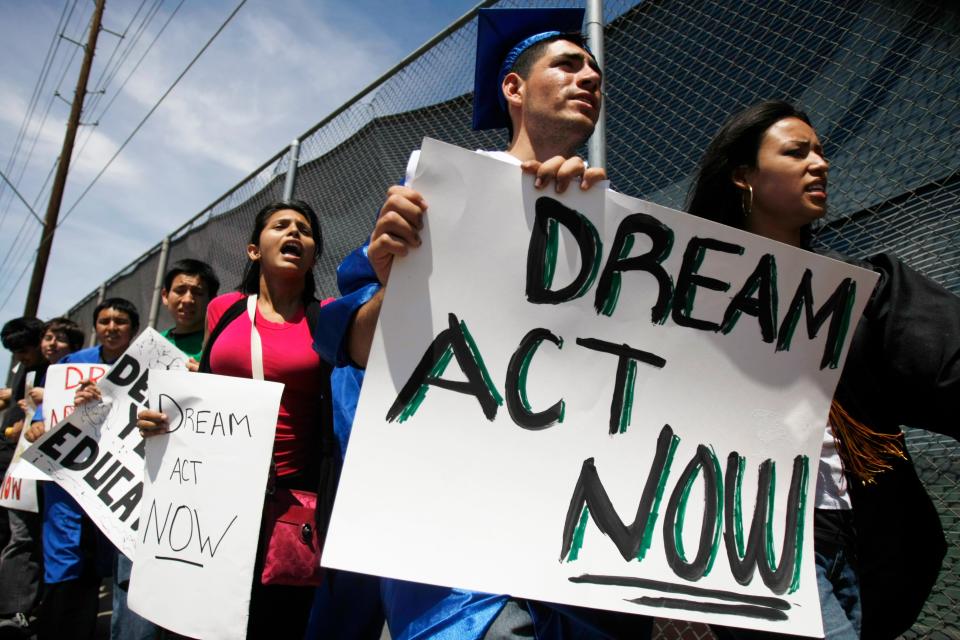 Jose Patino, then an ASU student, wears a graduation cap and gown in 2010 while marching in support of the DREAM Act.