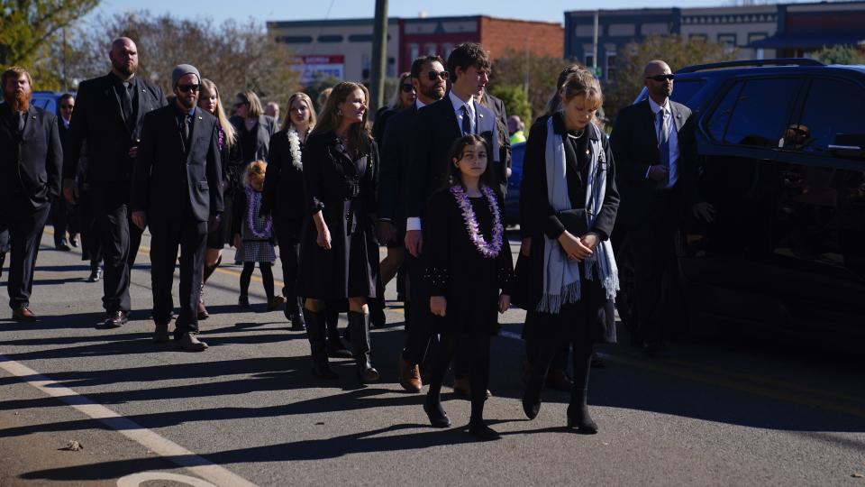 Carter family members follow the hearse during the funeral service for former first lady Rosalynn Carter, Wednesday, Nov. 29, 2023, in Plains, Ga. The former first lady died on Nov. 19. She was 96. (AP Photo/Brynn Anderson)