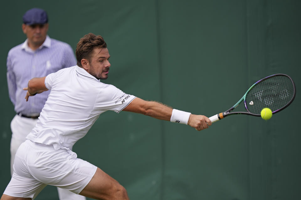 Switzerland's Stan Wawrinka returns to Argentina's Tomas Martín Etcheverry in a men's singles match on day four of the Wimbledon tennis championships in London, Thursday, July 6, 2023. (AP Photo/Alberto Pezzali)