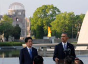 <p>President Barack Obama , flanked by Japanese Prime Minister Shinzo Abe, delivers a speech as the atomic bomb dome is background after they laid wreaths to a cenotaph at Hiroshima Peace Memorial Park in Hiroshima, Japan May 27, 2016. (Photo: Carlos Barria/Reuters) </p>
